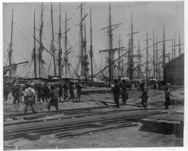 Durban, circa 1901. Handling rails at harbour with sailing vessels in the background. (Durban Har...