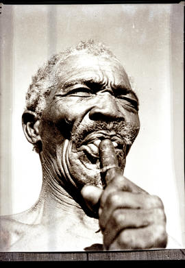 Namibia, 1937. Hottentot man playing reed flute.