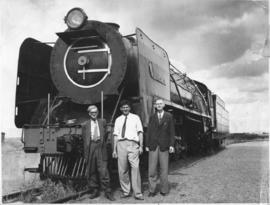 Three men posing at SAR Class 23 named "Port Elizabeth".