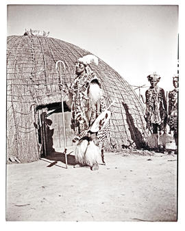 Natal, 1946. Zulu chief in front of hut.