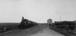 Konstabel, 1895. Cape 3rd Class 'Four coupled Joys' locomotive with train at station. (EH Short)