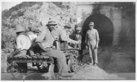 Workers on trolley at entrance to tunnel. (Lund collection)