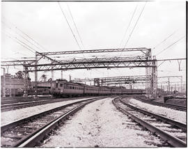 Johannesburg, 1952. Suburban train passing under overhead gantry at Germiston station.