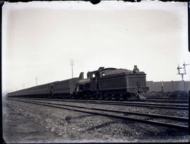 Cape Town. SAR Class 03 'Wynberg tender' locomotive on suburban train. Note spectacle plate on te...