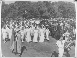 March past of men and women dressed in white.