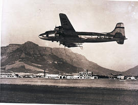 Cape Town, 1948. Wingfield airport. SAA Douglas DC-4 ZS-AUB 'Outeniqua' in flight. Note this is a...