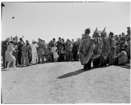 Maseru, Basutoland, 12 March 1947. Dignitaries photographing men in tribal dress.