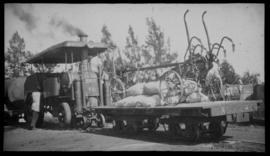 Dutton roadrail tractor No RR973 with loaded flat bed goods wagon.