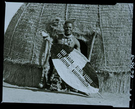 Zululand, 1957. Zulu warrior in front of hut.