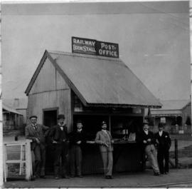 Johannesburg, 1892. Railway bookstall and post office in small tin shack with six men posing at J...