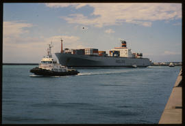 Port Elizabeth, 1986. SAR tug 'PJC du Plessis' leading container ship out of Port Elizabeth Harbo...
