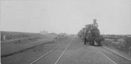 Letjiesbos, 1895. Cape 3rd Class 'Four-coupled Joys'  locomotive with station buildings in the di...
