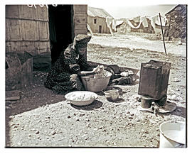 Windhoek, Namibia, 1952. Herero woman washing clothes in basin.