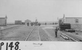 Bluecliff, 1895. Station buildings with small boy and sleepers in the foreground. (EH Short)