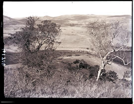 Transkei, 1932. Rolling hills with huts in the distance.