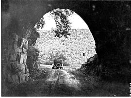 Waterval-Boven, 1926. Motor car leaving the abandoned old train tunnel on the original NZASM rail...