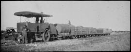 Dutton roadrail tractor No RR1155 with goods trucks.
