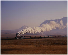 Bethlehem district, August 1987. SAR steam locomotive with passenger train near Slabberts. [D Dan...