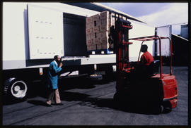
Forklift loading boxes into truck.
