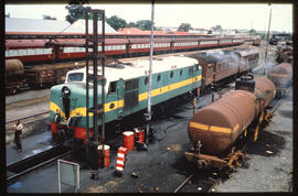 Mafeking, 1980. RR Class DE2 No 1221 taking diesel at railway station.