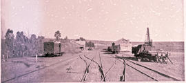 "Aliwal North, 1896. Railway tracks with station buildings in the distance."