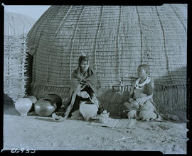 Zululand, 1957. Zulu woman shaping clay pots in front of hut.