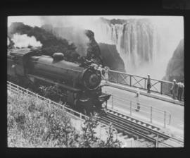 Victoria Falls, Rhodesia. Victoria Falls from the railway bridge, with Rhodesian Railways 11th cl...