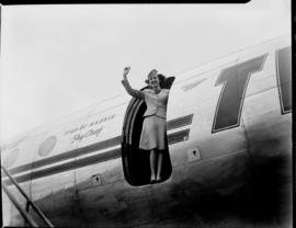 
Hostess Miss Dorothy Beck waving from open door of TWA Lockheed Constellation 'Star of Madrid' S...