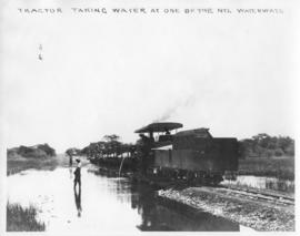 Naboomspruit district, circa 1924. Dutton road-rail tractor taking water from the Nyl waterway. (...