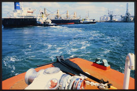 Richards Bay, 1991. SAR tug with ship in Richards Bay Harbour.