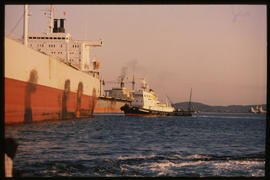 Richards Bay, July 1982. SAR tug with large ship in Richards Bay Harbour. [T Robberts]