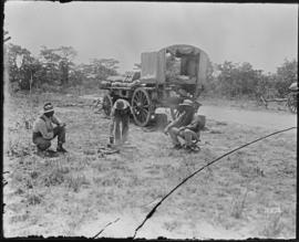 Zimbabwe. Cart with three men in open veld.