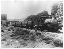 Okiep - Port Nolloth narrow gauge railway. Locomotive with train next to water tank.