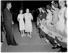 Ficksburg, 12 March 1947. Queen Elizabeth and Princess Margaret greeting women who are holding So...