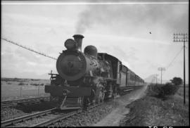 Cape Town district. SAR Class 10B locomotive with passenger train in open country.