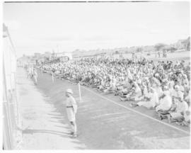 Bechuanaland, 17 April 1947. Crowd seated alongside Pilot Train at wayside station.