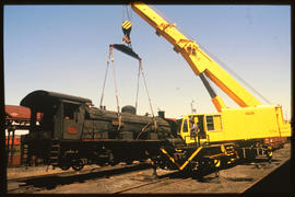 
SAR Class 12R No 1503 being lifted from rails by SAR crane truck No 592.
