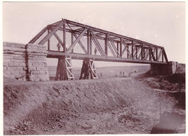 Circa 1900. Long span steel bridge with temporary supports, probably after repairs of damage duri...