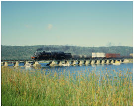 Knysna district, February 1987. SAR Class 24 on goods train on bridge over lagoon. [T Robberts]