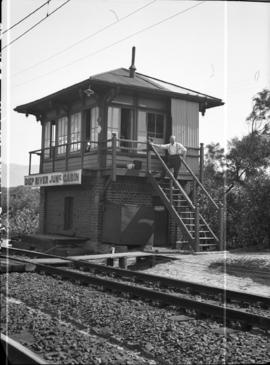 Cape Town. Man posing on the stairs of signal cabin at Diep River Junction.