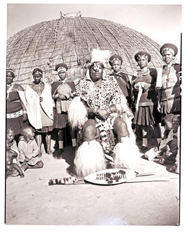 Natal, 1946. Zulu chief with his wives in front of hut.