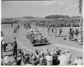 Eshowe, 19 March 1947. Queen Elizabeth and King George VI standing up in open Daimler to greet th...