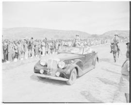 Lobatsi, Bechuanaland, 17 April 1947. King George VI and Queen Elizabeth drive through welcoming ...