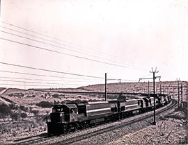 Vryheid district, 1978. SAR Class 34-600 heading other locomotives and goods train.