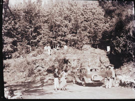"1936. Group with motor car parked at the edge of forest."