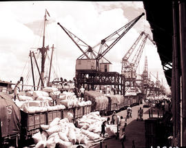 "1936. Loading of bags on train in harbour."