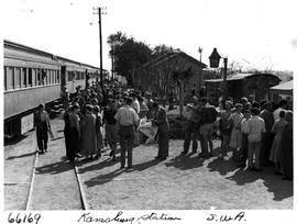 Karasburg, South-West Africa. Crowd alongside passenger train at Karasburg station platform.