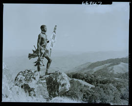 Zululand, 1957. Zulu warrior standing on rock.