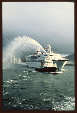 Cape Town, 1985. SAR tug leading 'Astor' passenger ship out of Table Bay Harbour.