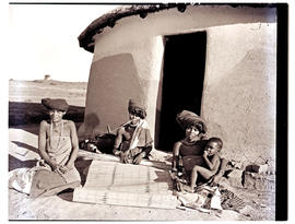 Transkei, 1952. Three Xhosa women with baby at hut.